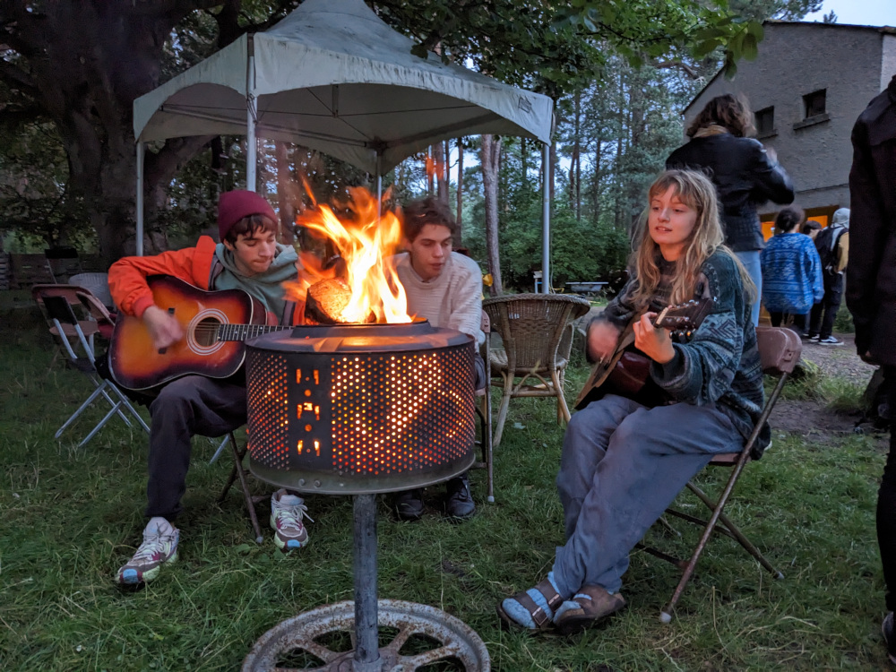 Teens at campfire singing